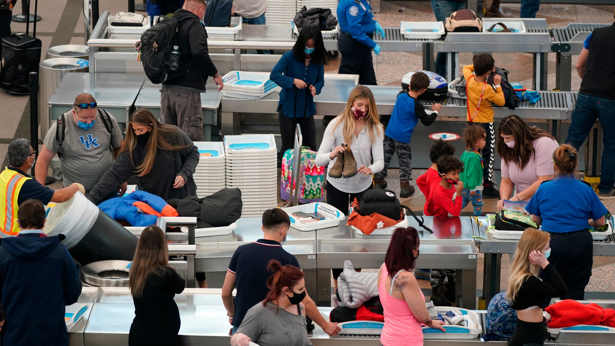 Travelers wear face masks while passing through the south security checkpoint in the main terminal of Denver International Airport Tuesday, Dec. 22, 2020, in Denver. (David Zalubowski/AP Photo)