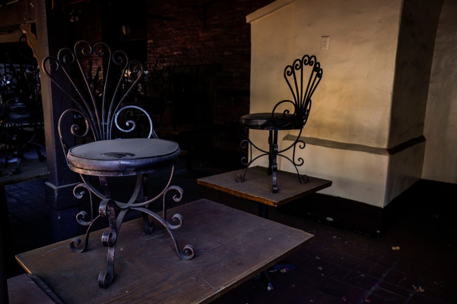 Dusty chairs are placed on top of dining tables in the patio area of a shuttered restaurant on Olvera Street in downtown Los Angeles, Tuesday, Dec. 15, 2020. Olvera Street, known as the birthplace of Los Angeles, has been particularly hard hit by the coronavirus pandemic, with shops and restaurants closed and others barely hanging on. (Jae C. Hong / Associated Press)