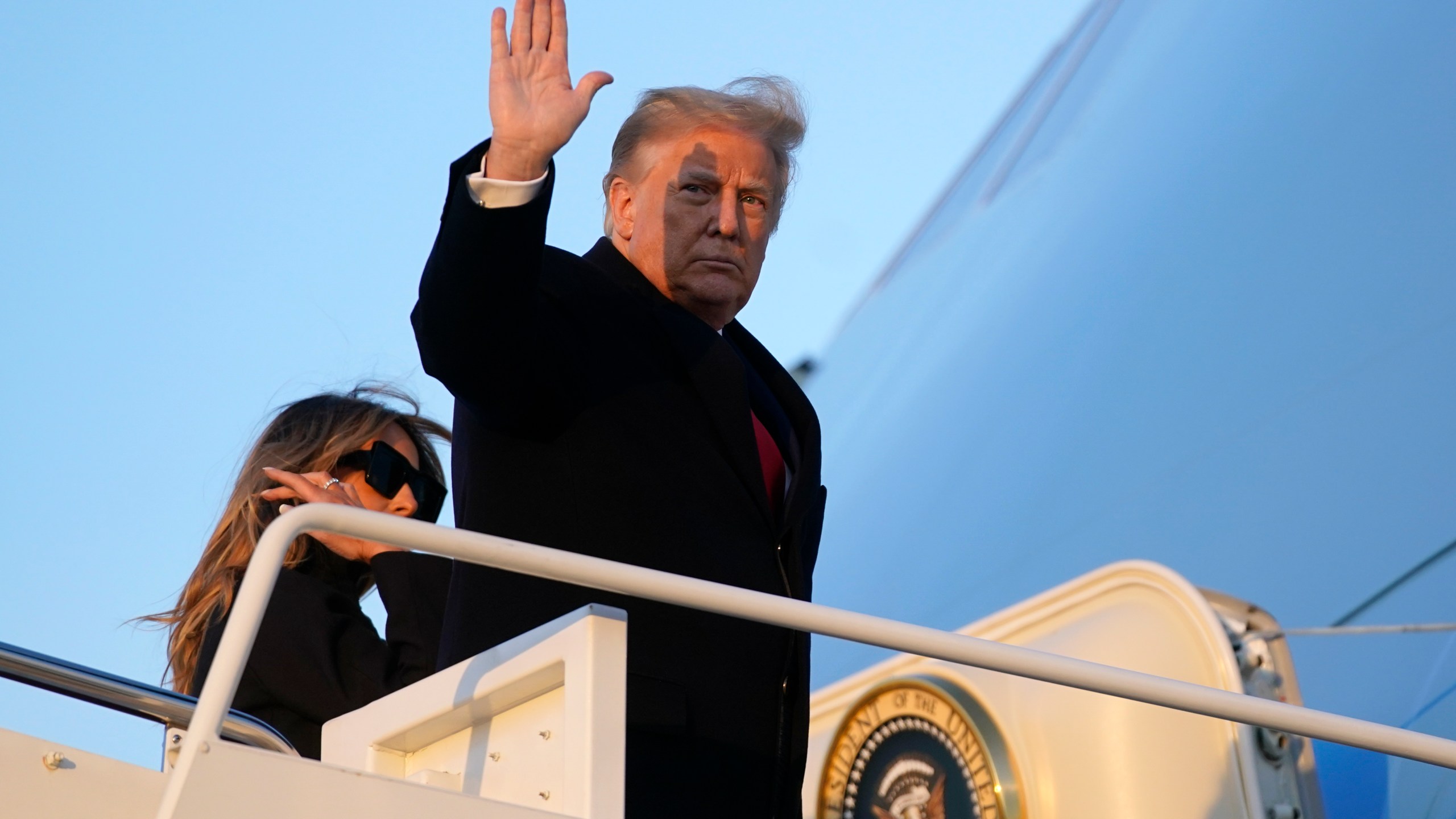 President Donald Trump waves as he boards Air Force One at Andrews Air Force Base, Md., on Dec. 23, 2020, en route to his Mar-a-Lago resort in Palm Beach, Fla. (Patrick Semansky / Associated Press)