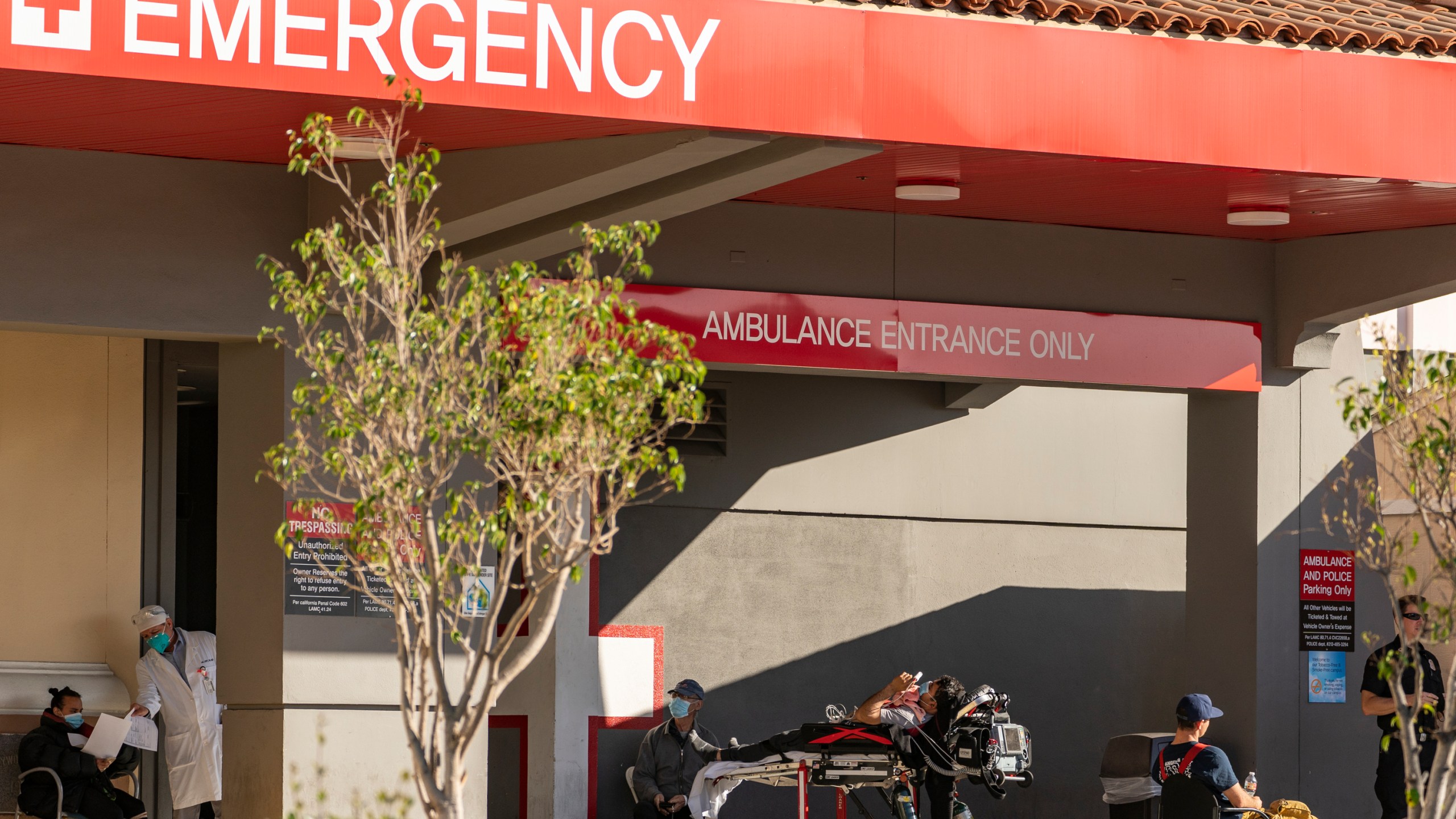 In this Dec. 18, 2020 file photo an unidentified patient receives oxygen on a stretcher, while Los Angeles Fire Department Paramedics monitor him outside the Emergency entrance, waiting for admission at the CHA Hollywood Presbyterian Medical Center in Los Angeles. (Damian Dovarganes/AP Photo)