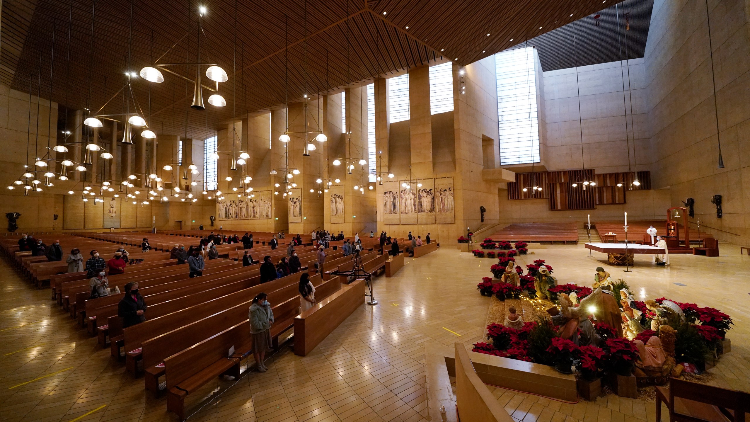 Worshipers gather for Christmas Eve Mass inside the Cathedral of Our Lady of the Angels Thursday, Dec 24, 2020, in Los Angeles. (AP Photo/Ashley Landis)