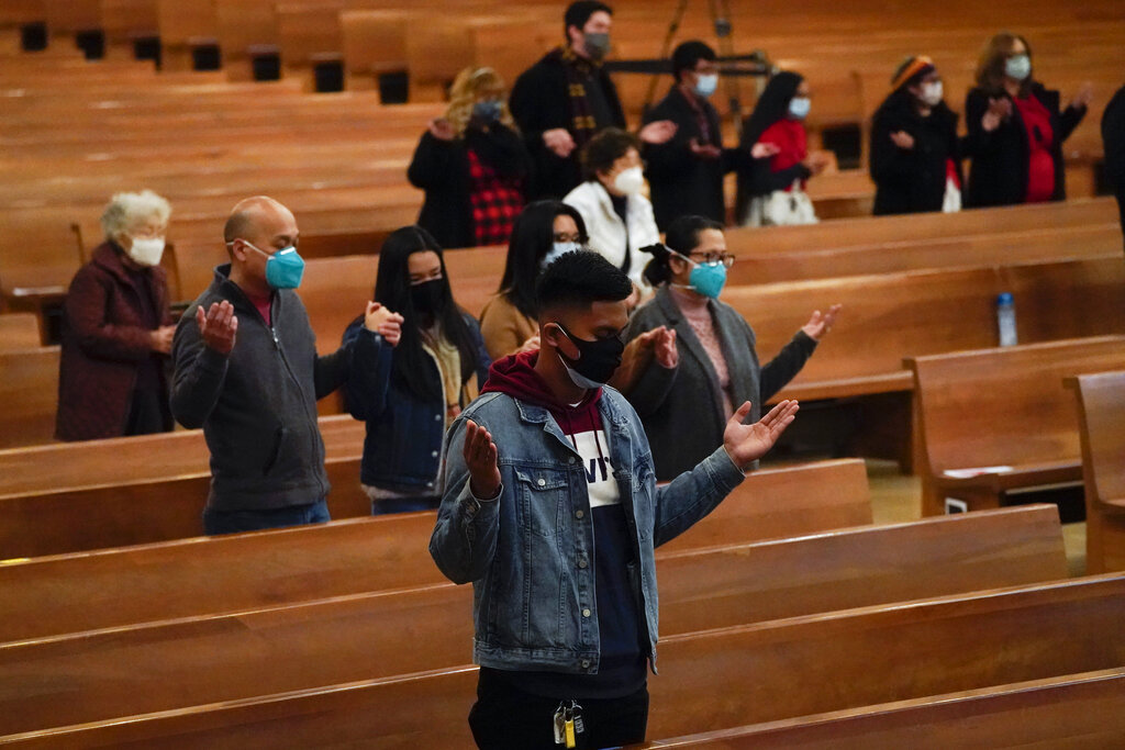 Worshipers gather for a Christmas Eve mass inside Cathedral of Our Lady of the Angels Thursday, Dec 24, 2020, in Los Angeles. (AP Photo/Ashley Landis)