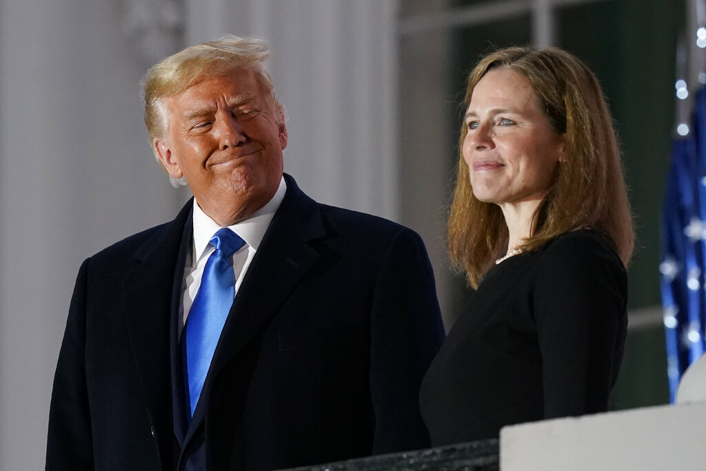 In this Monday, Oct. 26, 2020 file photo, President Donald Trump and Amy Coney Barrett stand on the Blue Room Balcony after Supreme Court Justice Clarence Thomas administered the Constitutional Oath to her on the South Lawn of the White House White House in Washington. (AP Photo/Patrick Semansky, File)