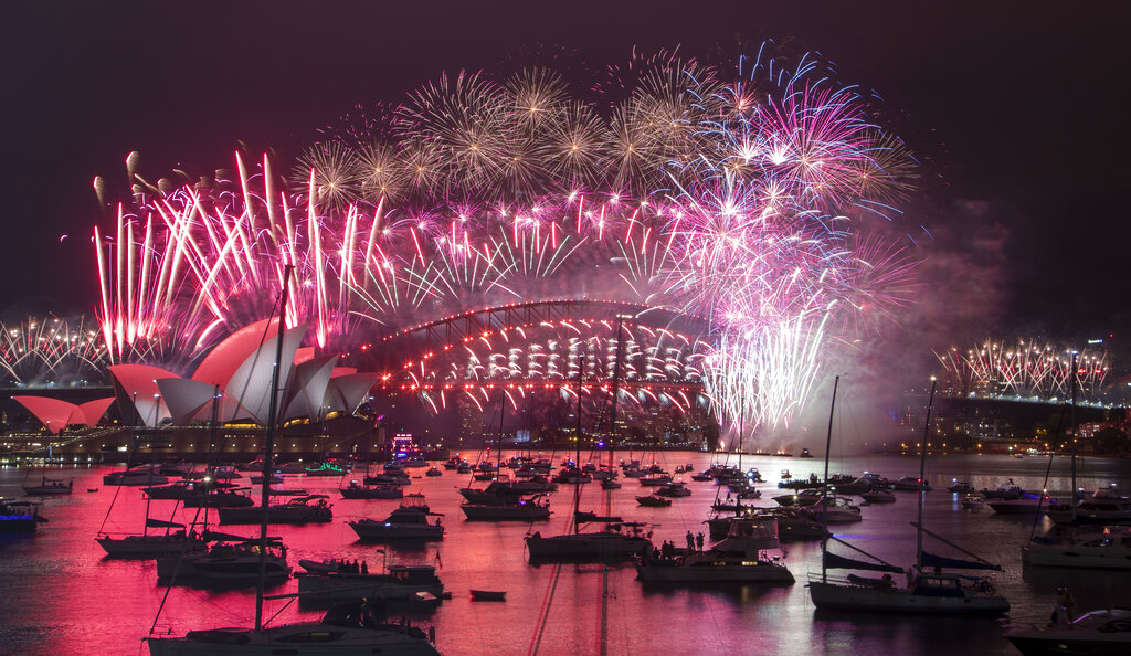 Fireworks explode over the Sydney Opera House and Harbour Bridge as New Year celebrations begin in Sydney, Australia, Friday, Jan. 1, 2021.