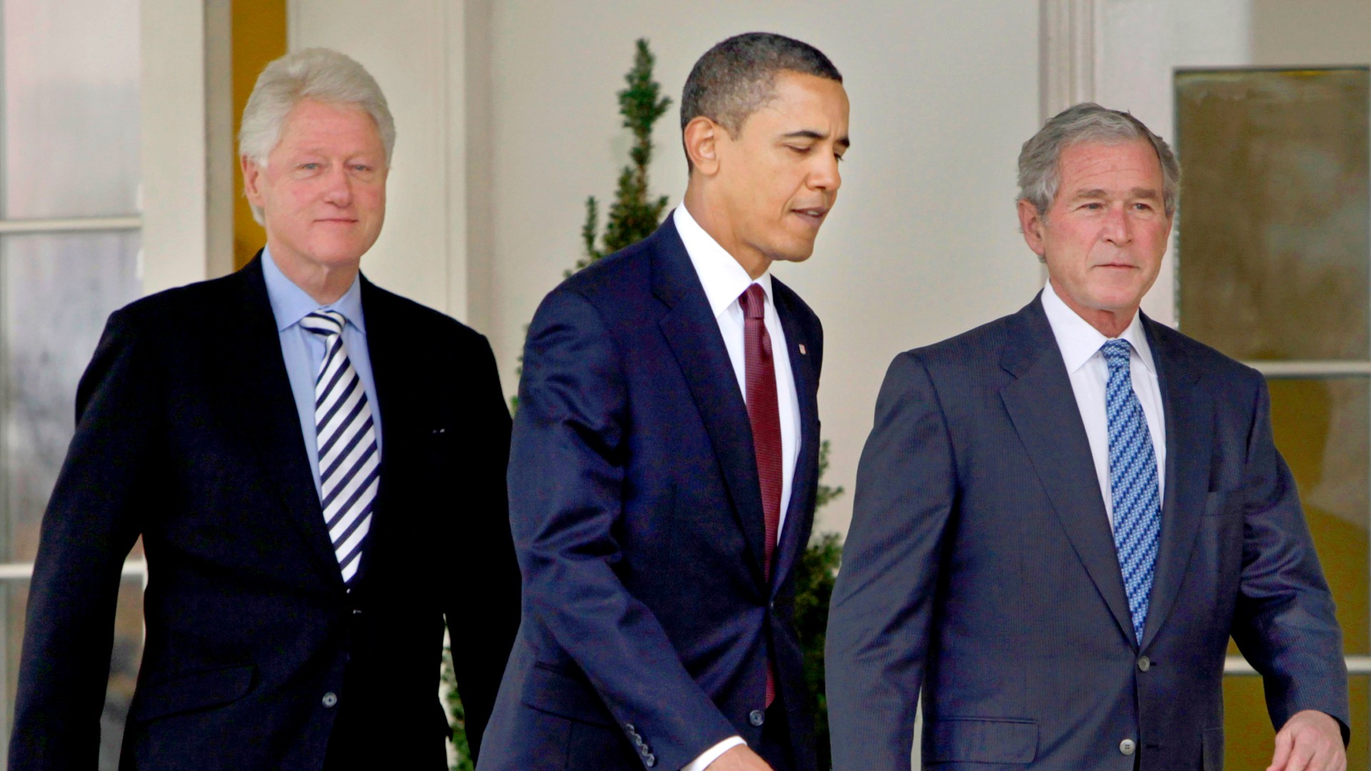 In this Jan. 16, 2010, file photo President Barack Obama, center, walks out of the Oval Office of the White House with former Presidents Bill Clinton, left, and George W. Bush, right, to deliver remarks in the Rose Garden at the White House in Washington. Three former presidents say they'd be willing to take a coronavirus vaccine publicly, once one becomes available, to encourage all Americans to get inoculated against a disease that has already killed more than 273,000 people nationwide. (AP Photo/Pablo Martinez Monsivais, File)