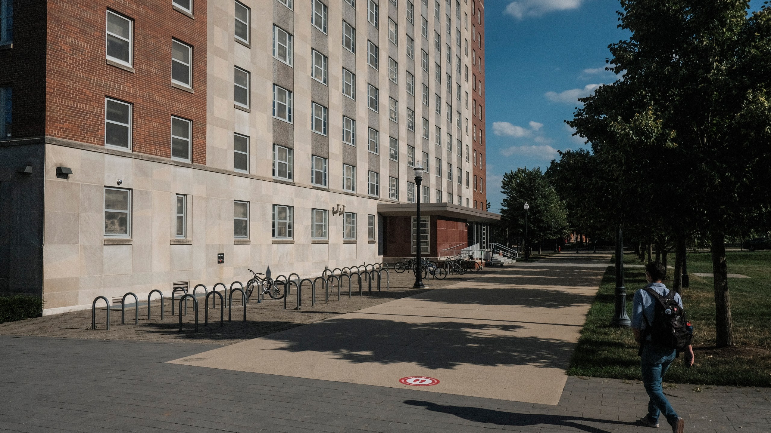 A lone figure walks across a normally busy area of campus near the 'Oval' at Ohio State University on August 13, 2020 in Columbus, Ohio. (Matthew Hatcher/Getty Images)