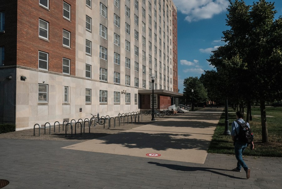 A lone figure walks across a normally busy area of campus near the 'Oval' at Ohio State University on August 13, 2020 in Columbus, Ohio. (Matthew Hatcher/Getty Images)