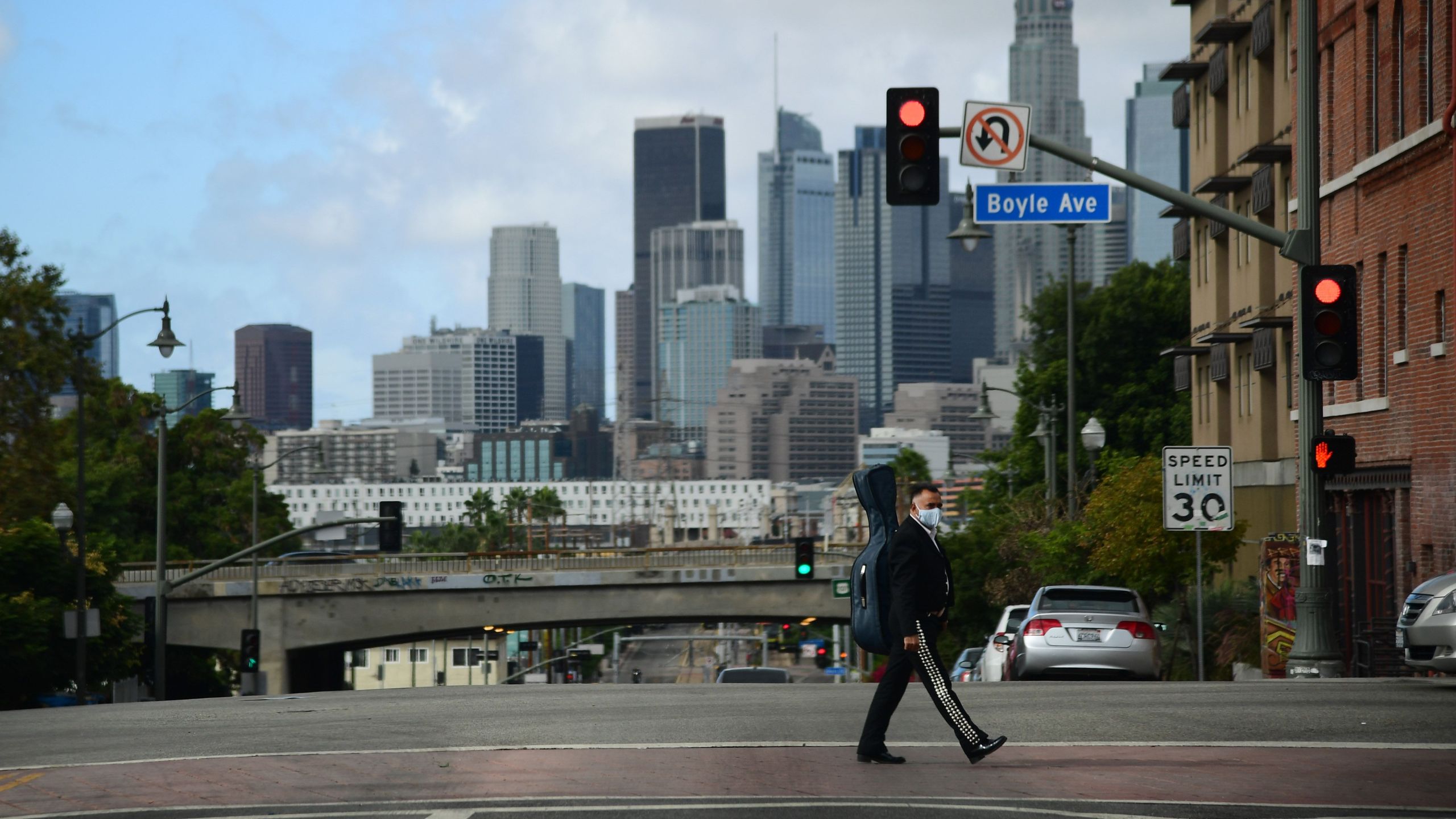 A musician walks towards Mariachi Plaza in Boyle Heights on Nov. 7, 2020. (Robyn Beck / AFP via Getty Images)