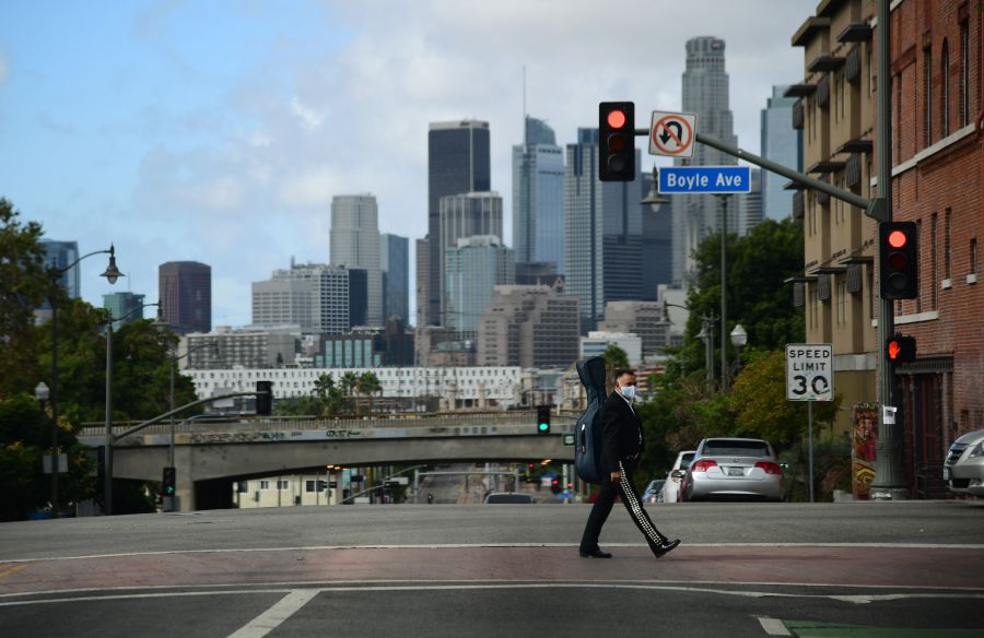 A musician walks towards Mariachi Plaza in Boyle Heights on Nov. 7, 2020. (Robyn Beck / AFP via Getty Images)