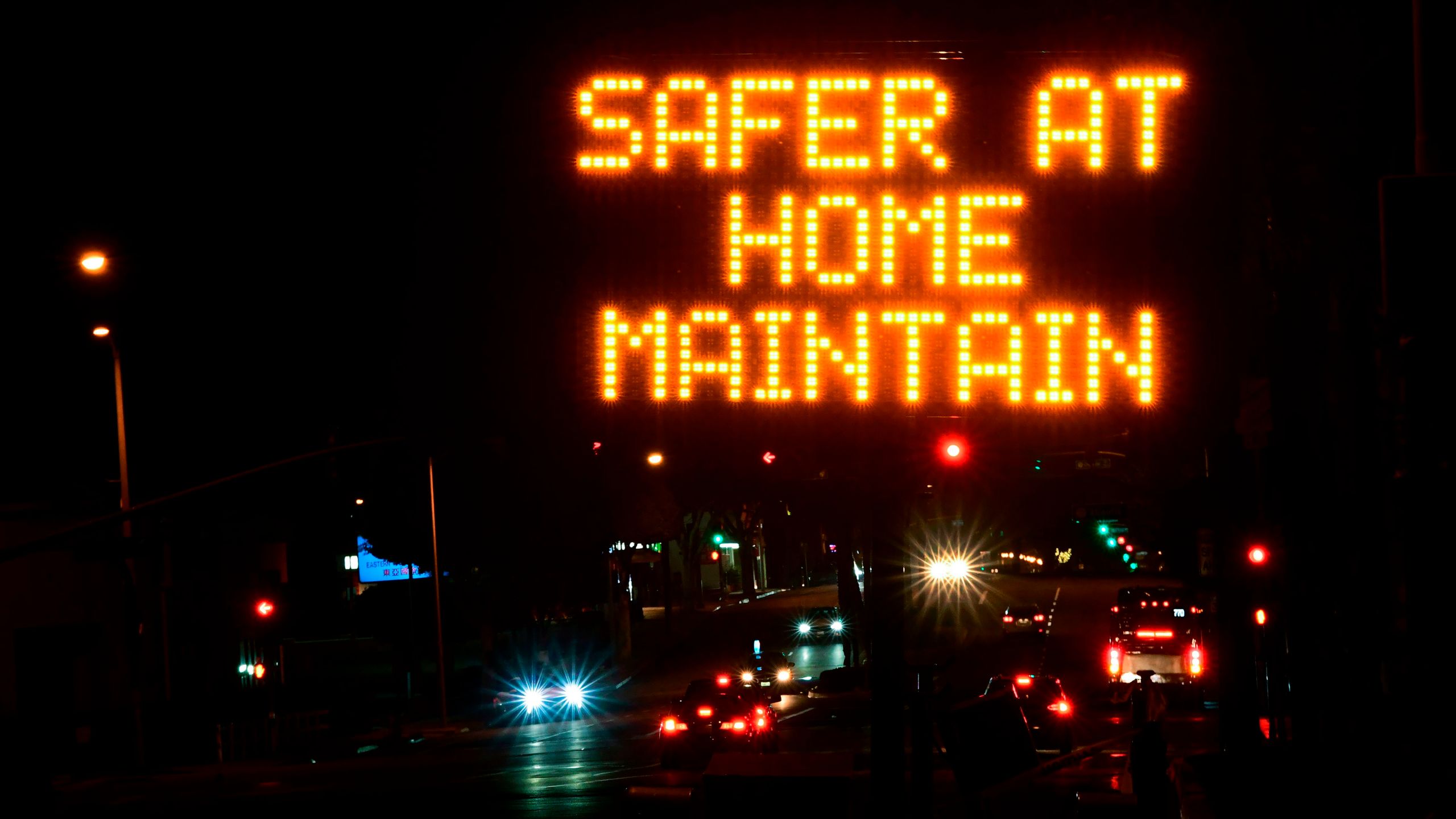 A sign reminds motorists of the Los Angeles County stay-at-home regulation in place for the next three weeks on Dec. 1, 2020. (FREDERIC J. BROWN/AFP via Getty Images)