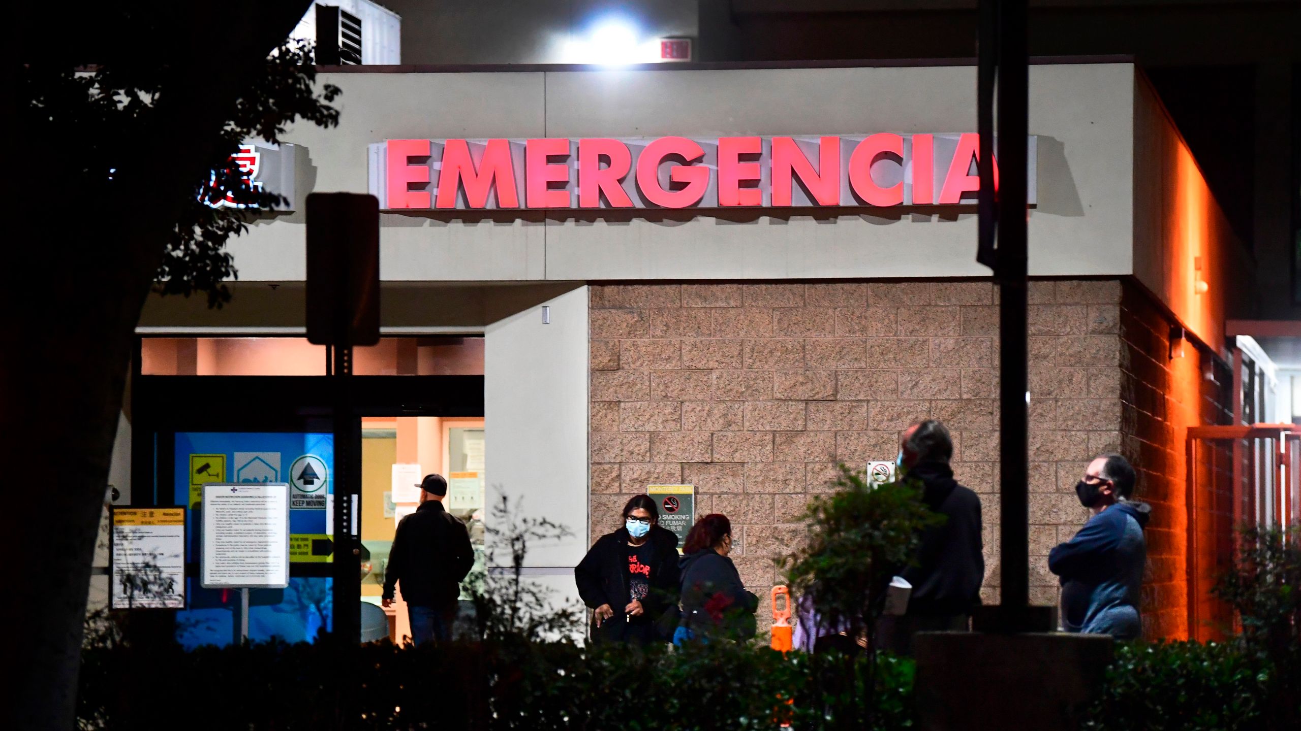 People wait outside the emergency room of the Garfield Medical Center in Monterey Park on Dec. 1, 2020. (FREDERIC J. BROWN/AFP via Getty Images)