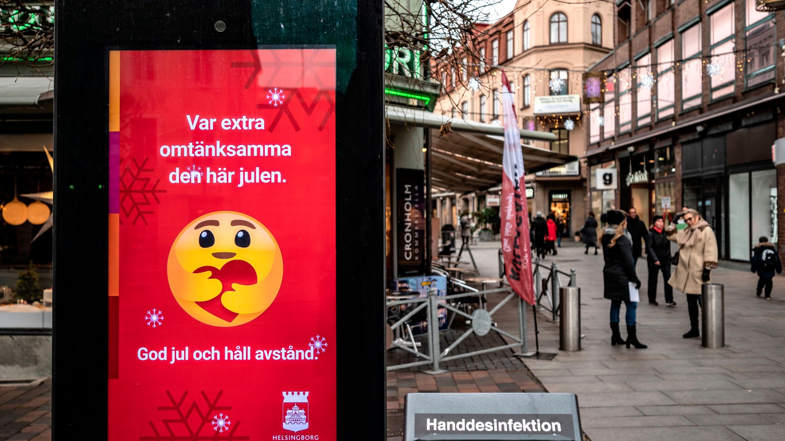 An information sign wishing Merry Christmas and asking to maintain social distancing is seen in a pedestrian shopping street in Helsingborg, southern Sweden, on December 7, 2020. (JOHAN NILSSON/TT News Agency/AFP via Getty Images)