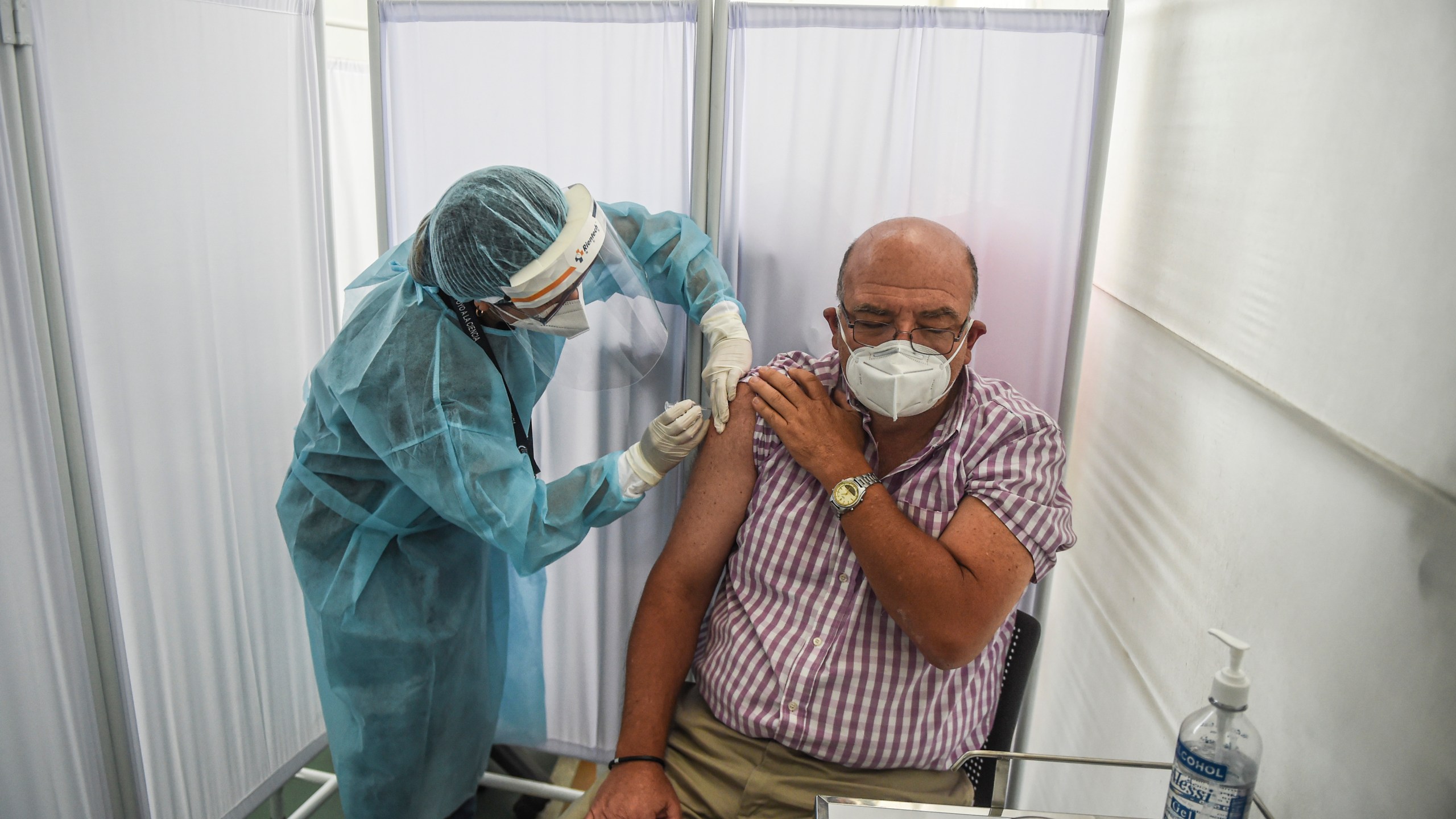 A health worker inoculates a volunteer with a COVID-19 vaccine produced by the Chinese Sinopharm during its trial at the Clinical Studies Center of the Cayetano Heredia University in Lima on Dec. 9, 2020. (ERNESTO BENAVIDES/AFP via Getty Images)