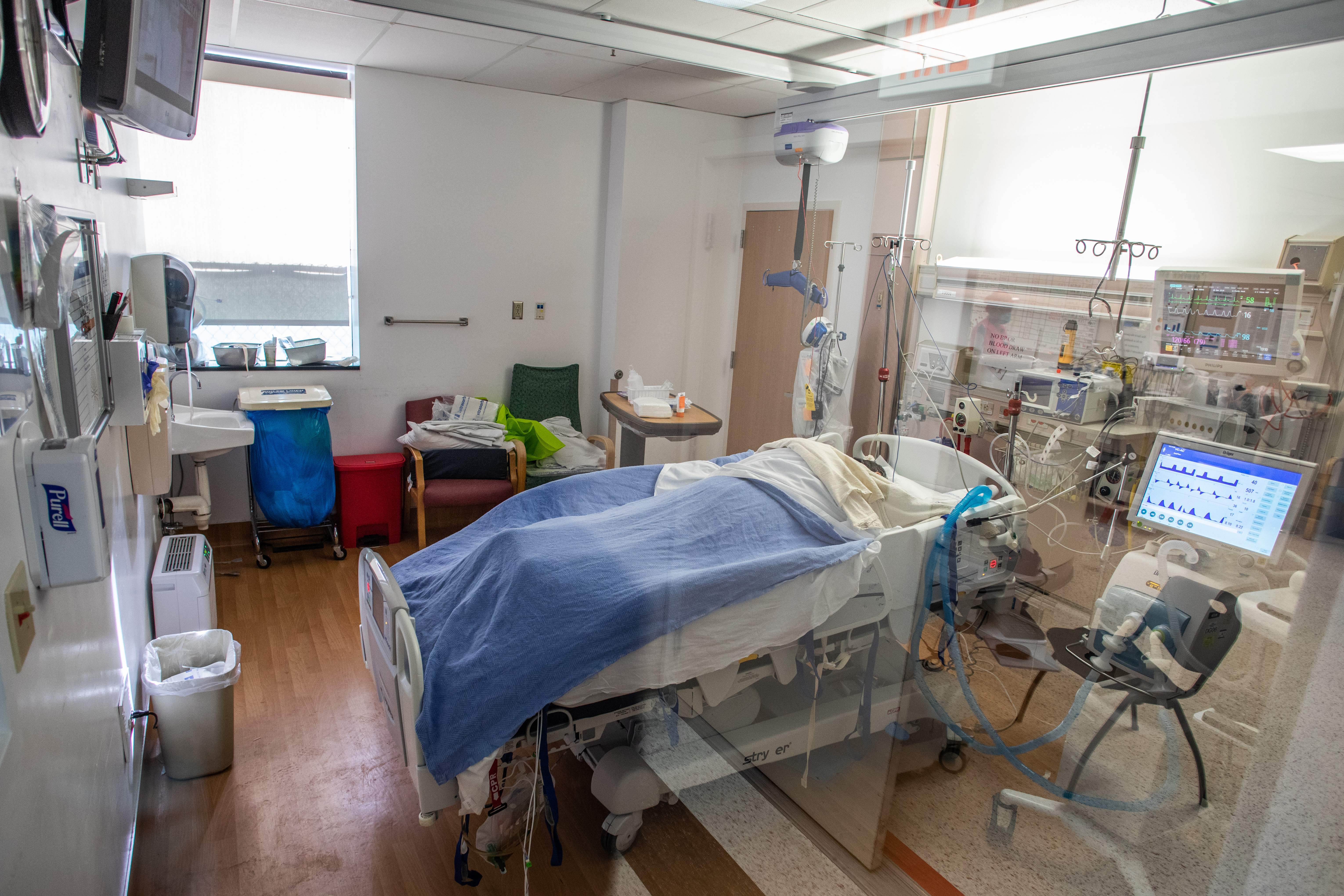 A Covid-19 patient lies on a bed in an Intensive Care Unit (ICU) at Providence Cedars-Sinai Tarzana Medical Center in Tarzana, California on December 18, 2020. (Apu Gomes/AFP via Getty Images)