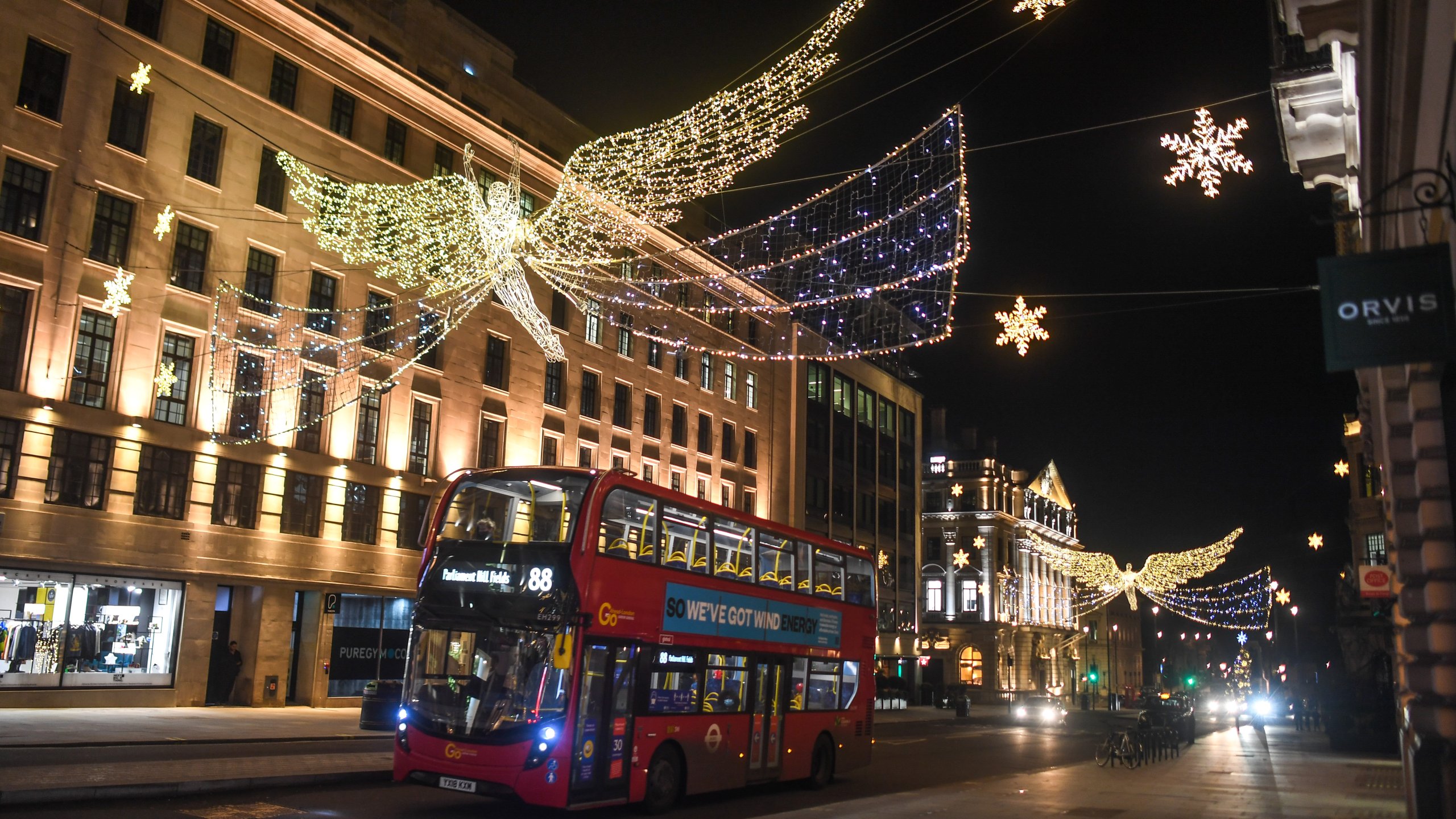 A bus is seen driving under festive lights on Dec. 20, 2020 in London, England. London and large parts of southern England were moved into a newly created "Tier 4" lockdown, closing non-essential shops and limiting household mixing. The government also scrapped a plan to allow multi-household "bubbles" to form for over a 5-day period around Christmas. (Peter Summers/Getty Images)