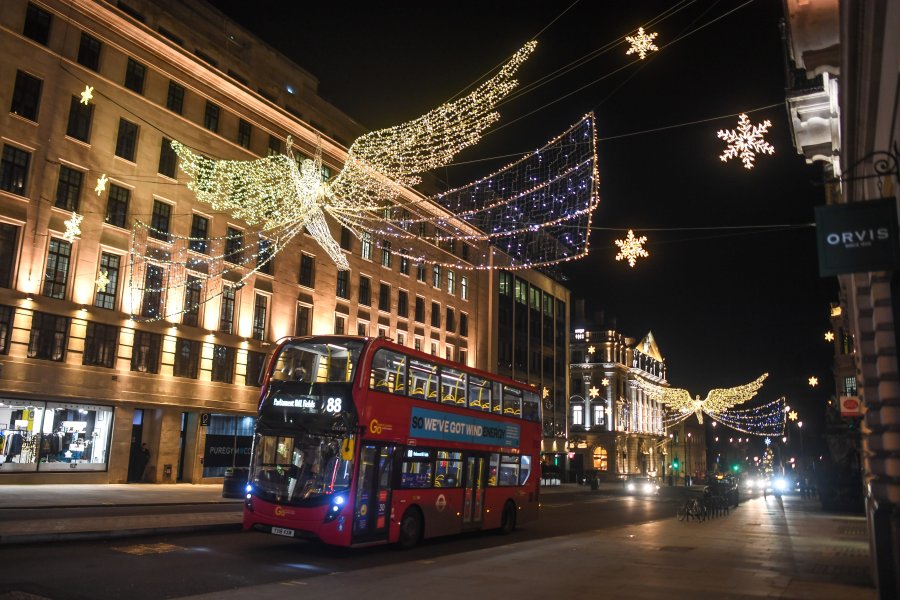 A bus is seen driving under festive lights on Dec. 20, 2020 in London, England. London and large parts of southern England were moved into a newly created "Tier 4" lockdown, closing non-essential shops and limiting household mixing. The government also scrapped a plan to allow multi-household "bubbles" to form for over a 5-day period around Christmas. (Peter Summers/Getty Images)