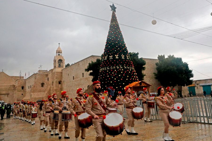 A Palestinian scouts band parades in front of the Church of the Nativity during Christmas celebrations in the biblical city of Bethlehem in the occupied West Bank, on December 24, 2020. (HAZEM BADER/AFP via Getty Images)