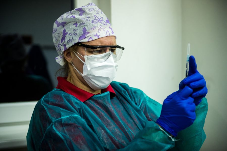 A medic holds a syringe with a vaccine against the novel coronavirus COVID-19 as first people receive a vaccination on Dec. 26, 2020, in the faculty hospital in Nitra, western Slovakia. (VLADIMIR SIMICEK/AFP via Getty Images)