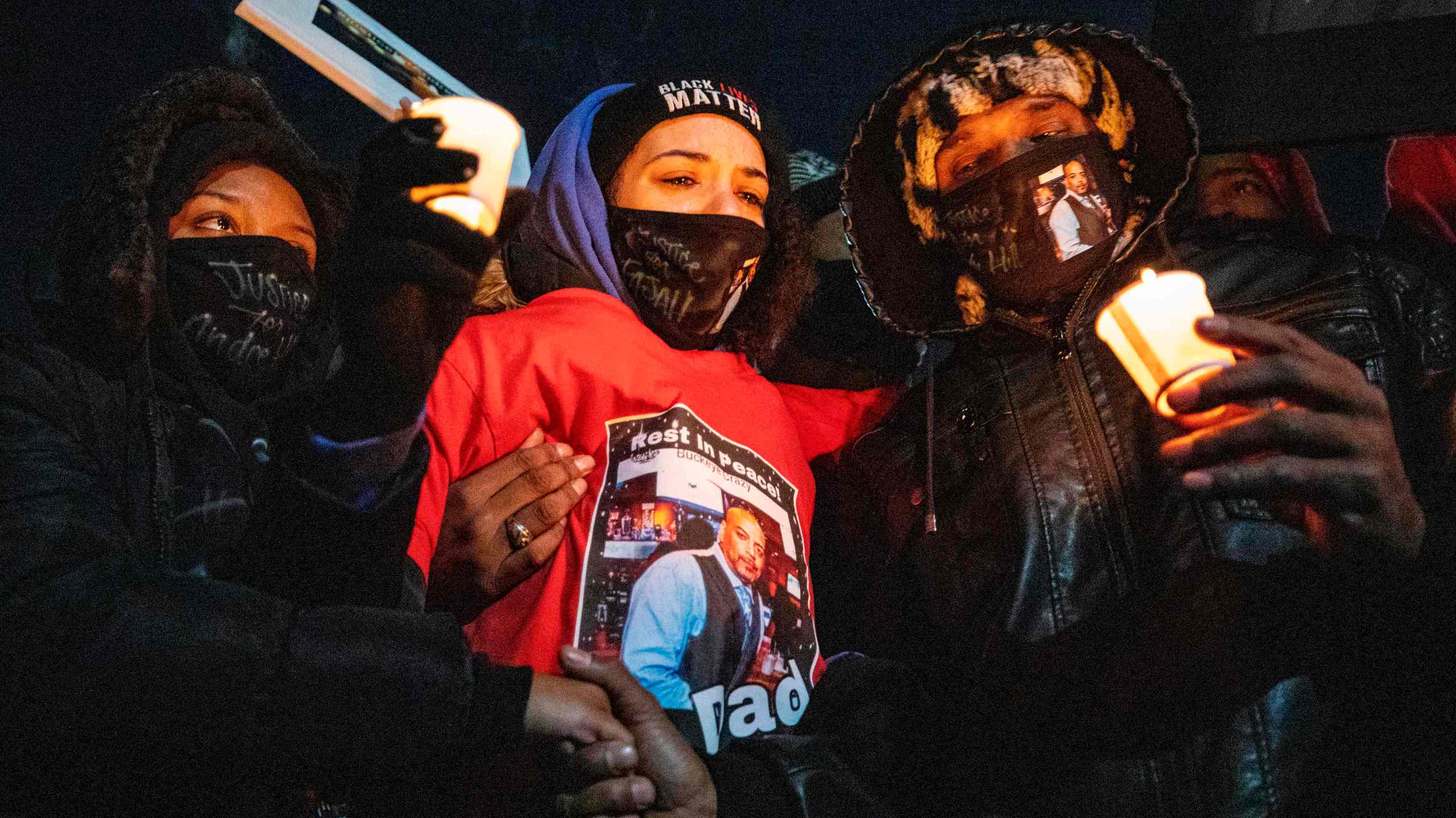 Karissa Hill, center, Andre Hills daughter, is comforted by friends and loved ones at a press conference and candlelight vigil to honor her father's memory outside the Brentnell Community Recreation Center in Columbus, Ohio, on Dec. 26, 2020. (Stephen Zenner / AFP / Getty Images)