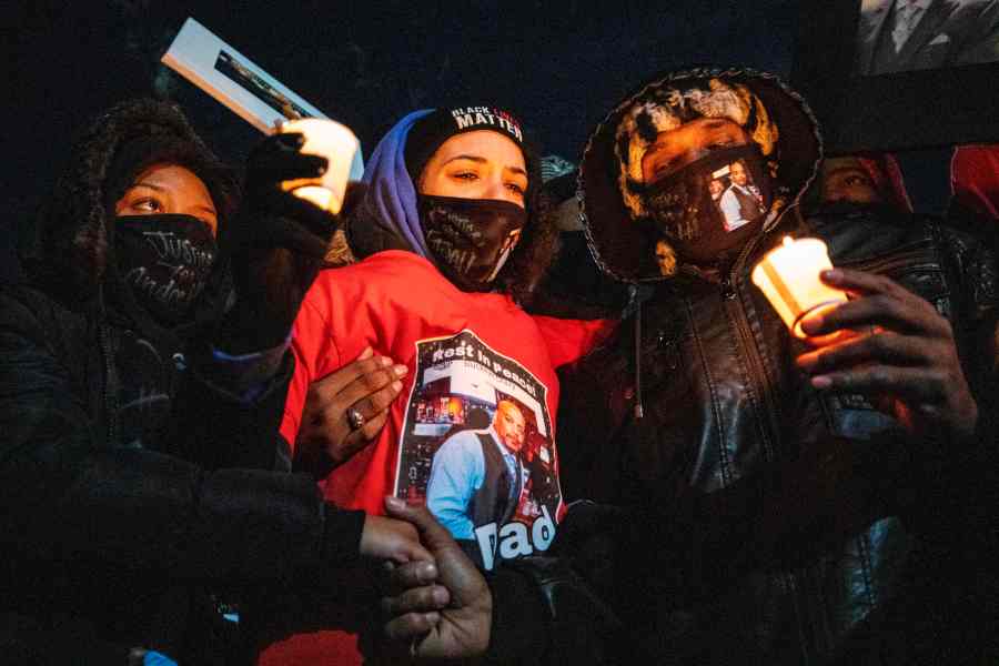 Karissa Hill, center, Andre Hills daughter, is comforted by friends and loved ones at a press conference and candlelight vigil to honor her father's memory outside the Brentnell Community Recreation Center in Columbus, Ohio, on Dec. 26, 2020. (Stephen Zenner / AFP / Getty Images)