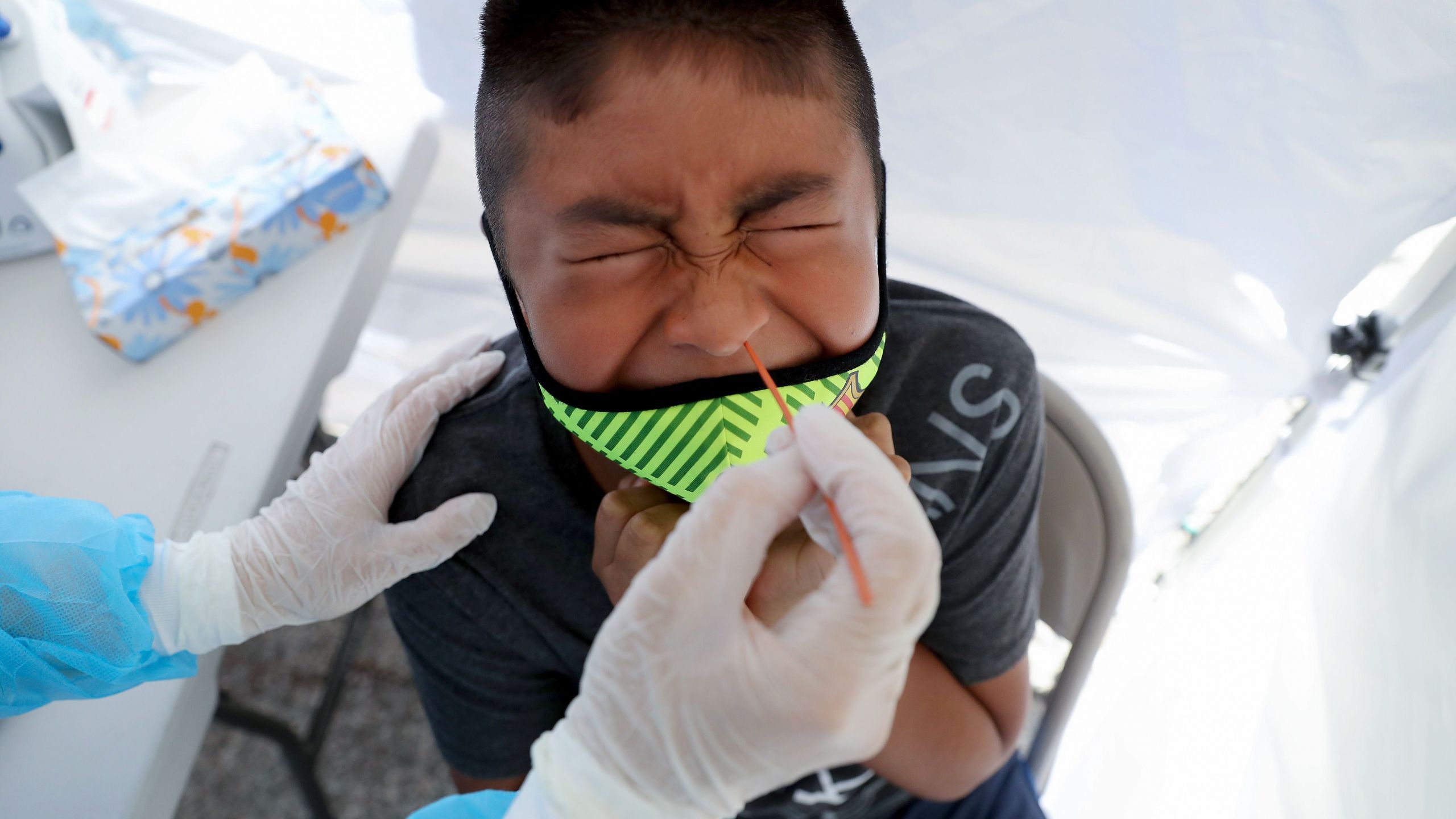 A boy receives a free coronavirus test at a St. John’s Well Child & Family Center mobile clinic set up outside Walker Temple AME Church in South Los Angeles on July 15, 2020. (Mario Tama/Getty Images)