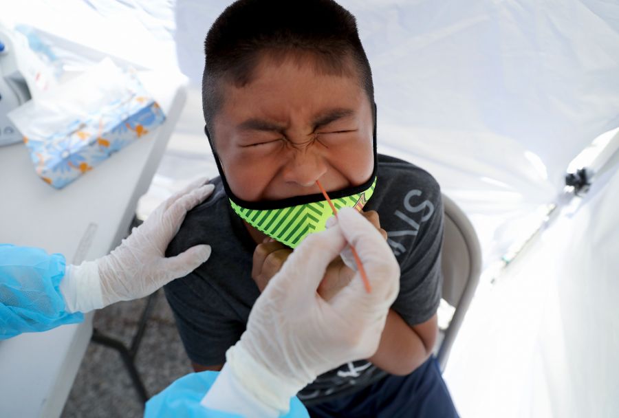 A boy receives a free coronavirus test at a St. John’s Well Child & Family Center mobile clinic set up outside Walker Temple AME Church in South Los Angeles on July 15, 2020. (Mario Tama/Getty Images)