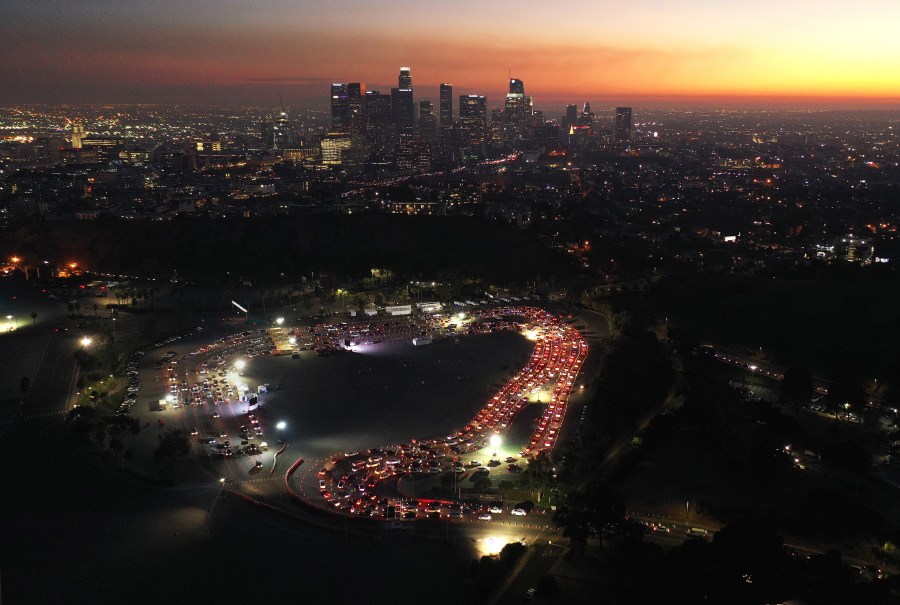 In an aerial view from a drone, cars are lined up at Dodger Stadium for COVID-19 testing as dusk falls over downtown Los Angeles on Dec. 2, 2020. (Mario Tama / Getty Images)