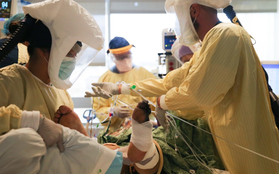 Clinicians work after manually proning a COVID-19 patient in the intensive care unit at Sharp Grossmont Hospital on Dec.14, 2020 in La Mesa, California. (Mario Tama/Getty Images)