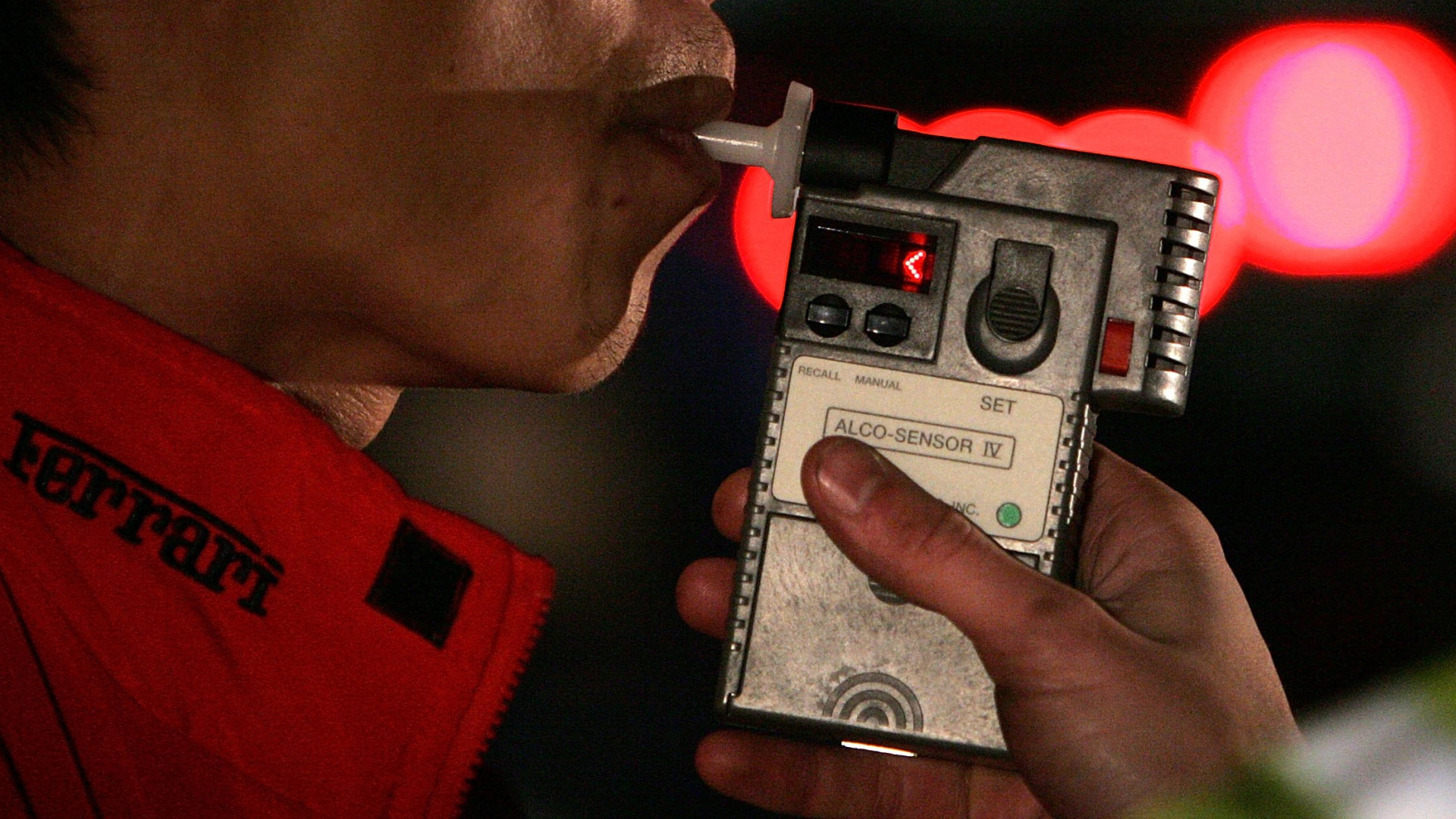 A man blows into a breathalizer during a field sobriety test after he was stopped by San Bruno Police officers at a DUI checkpoint Nov. 27, 2006 in San Bruno. (Justin Sullivan/Getty Images)