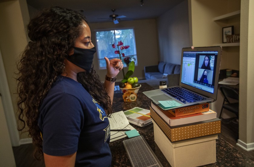 Cynthia Medrano, a college counselor at an LAUSD charter school in Sun Valley, works remotely at her home in Woodland Hills in 2020. Like other counselors, Medrano adjusted how she interacted with students amid remote learning, setting up dozens of one-on-one meetings and texting, emailing and calling students to ensure they filled out their college applications. (Mel Melcon / Los Angeles Times)