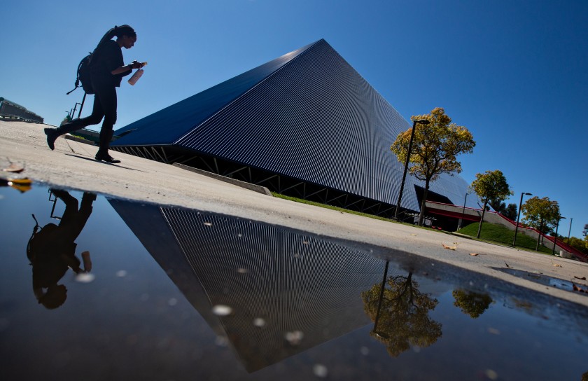 A student passes by the Walter Pyramid at Cal State Long Beach after the campus moved to online-only classes on March 11, 2020, because of the COVID-19 pandemic. (Jason Armond/ Los Angeles Times)