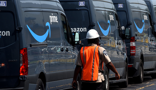 Amazon vans line up at a distribution center to pick up packages for delivery on Amazon Prime Day, July 16, 2019, in Orlando, Florida. (Photo by Paul Hennessy/NurPhoto via Getty Images)