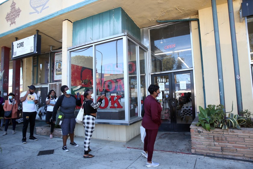 Customers wait in line to enter Eso Won Books in Leimert Park on Saturday, Nov. 28, 2020. (Dania Maxwell / Los Angeles Times)