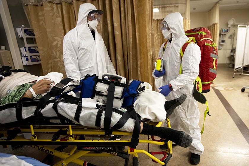 A COVID-19 patient who had a stroke is prepped to be flown from Providence St. Mary Medical Center to another hospital on Dec. 22, 2020. (Francine Orr / Los Angeles Times)