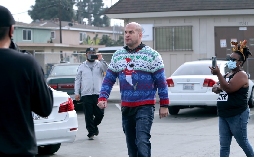 Huntington Beach Mayor Pro Tem Tito Ortiz is approached from all sides with cellphones and a megaphone for not wearing a mask during a food giveaway in the Oak View neighborhood of Huntington Beach on Dec. 23, 2020. (Raul Roa / Times Community News)