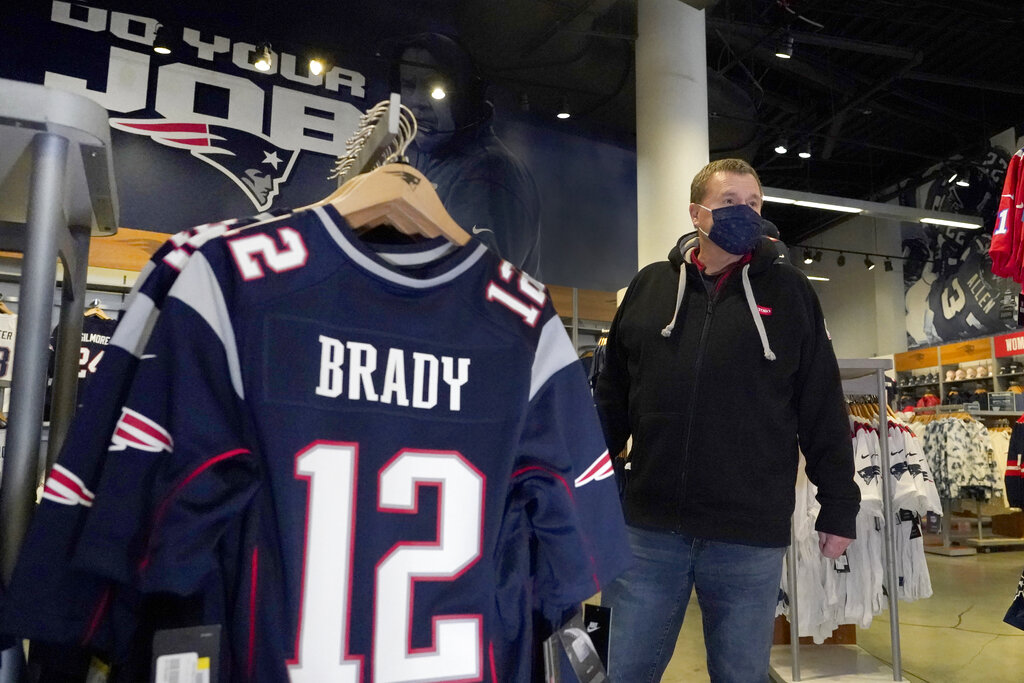 Football fan Brian Pope browses for Tom Brady jerseys in the pro shop at Gillette Stadium, Monday, Jan. 25, 2021, in Foxborough, Mass. Tom Brady is going to the Super Bowl for the 10th time, and New England Patriots football fans are cheering for him -- just like before. (AP Photo/Elise Amendola)