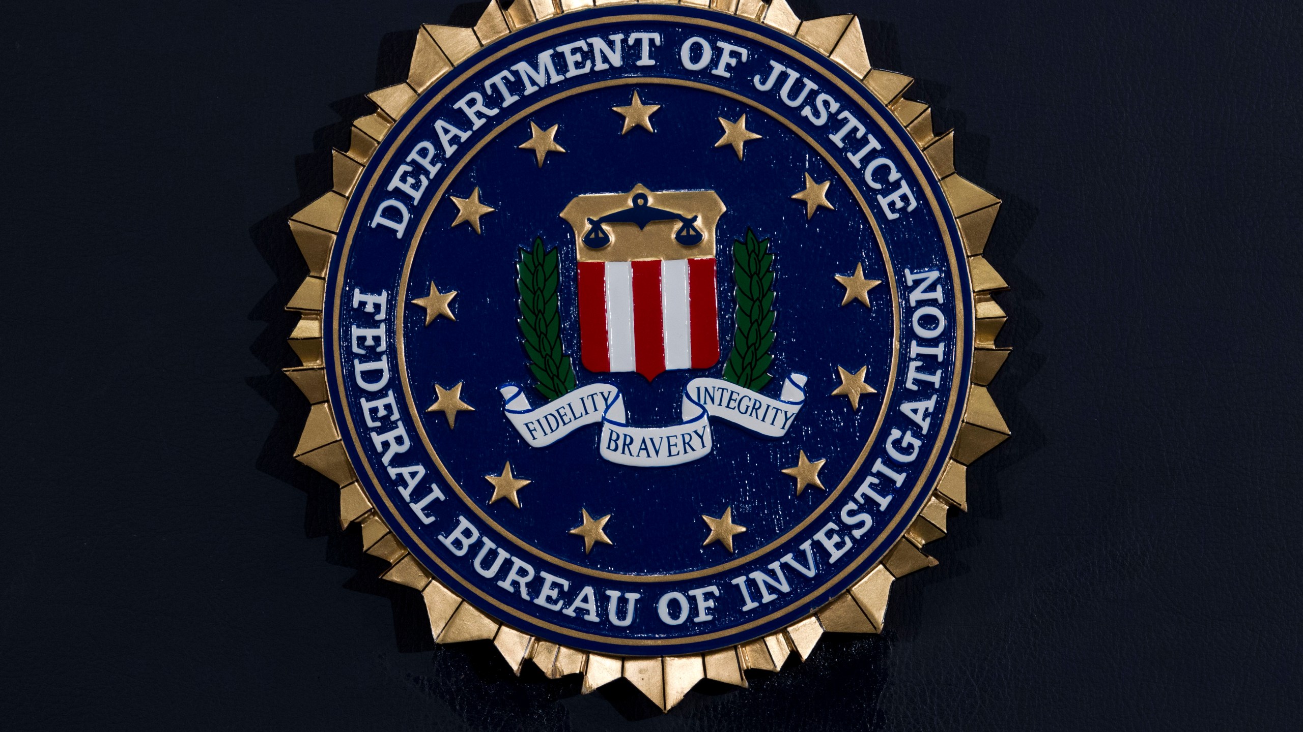 This Thursday, June 14, 2018, file photo, shows the FBI seal at a news conference at FBI headquarters in Washington.(AP Photo/Jose Luis Magana, File)