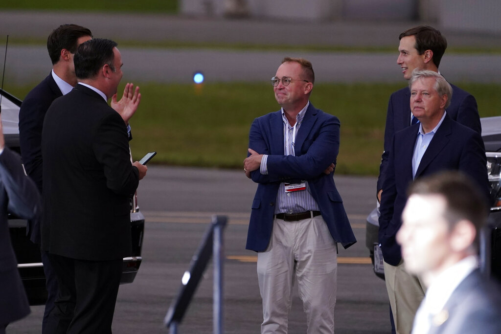 White House social media director Dan Scavino, from left, White House aide John McEntee former acting chief of staff Mick Mulvaney, White House adviser Jared Kushner and Sen. Lindsey Graham, R-S.C., talk as President Donald Trump speaks during a campaign rally at Smith Reynolds Airport on Sept. 8, 2020, in Winston-Salem, N.C. (AP Photo/Evan Vucci)