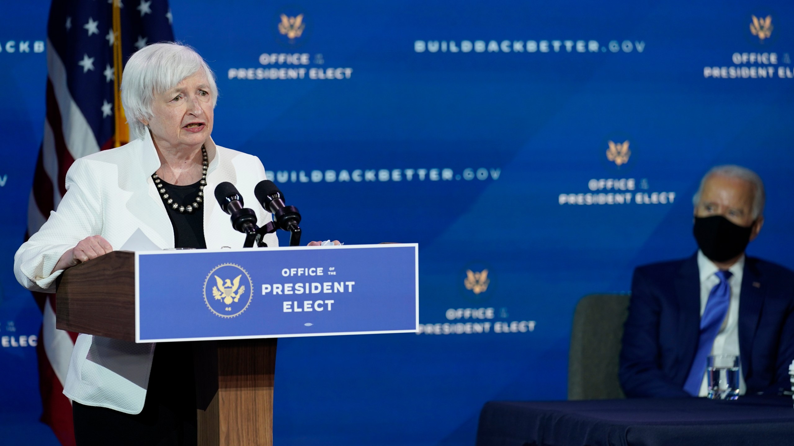 President-elect Joe Biden, right, listens as Janet Yellen, who Biden nominated to serve as Secretary of the Treasury, speaks at The Queen theater, Tuesday, Dec. 1, 2020, in Wilmington, Del. (AP Photo/Andrew Harnik)