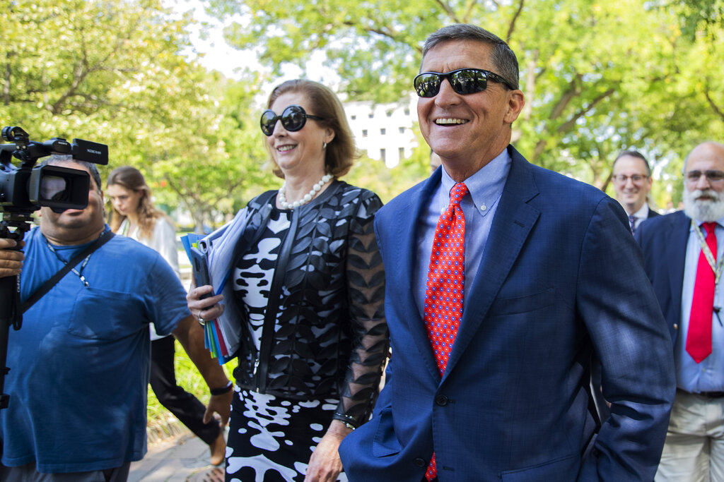 In this Sept. 10, 2019, file photo, Michael Flynn, President Donald Trump's former national security adviser from Middletown, R.I., leaves federal court with his lawyer Sidney Powell, left, following a status conference in Washington. (Manuel Balce Ceneta/ Associated Press File)