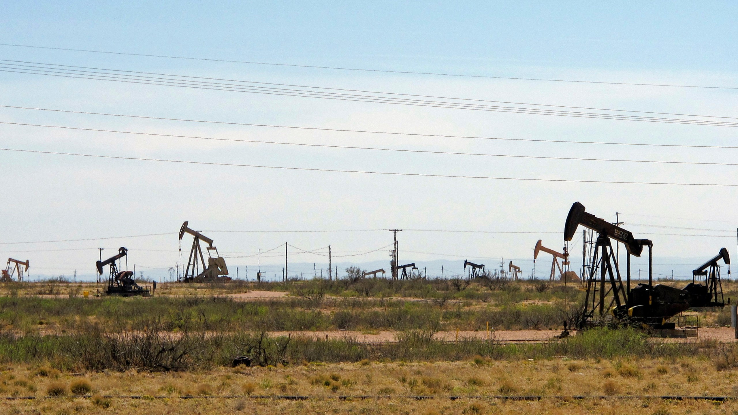 In this April 9, 2014, file photo, oil rigs stand in the Loco Hills field on U.S. Highway 82 in Eddy County near Artesia, N.M., one of the most active regions of the Permian Basin. President Joe Biden is set to announce a wide-ranging moratorium on new oil and gas leasing on U.S. lands, as his administration moves quickly to reverse Trump administration policies on energy and the environment and address climate change. (AP Photo/Jeri Clausing, File)