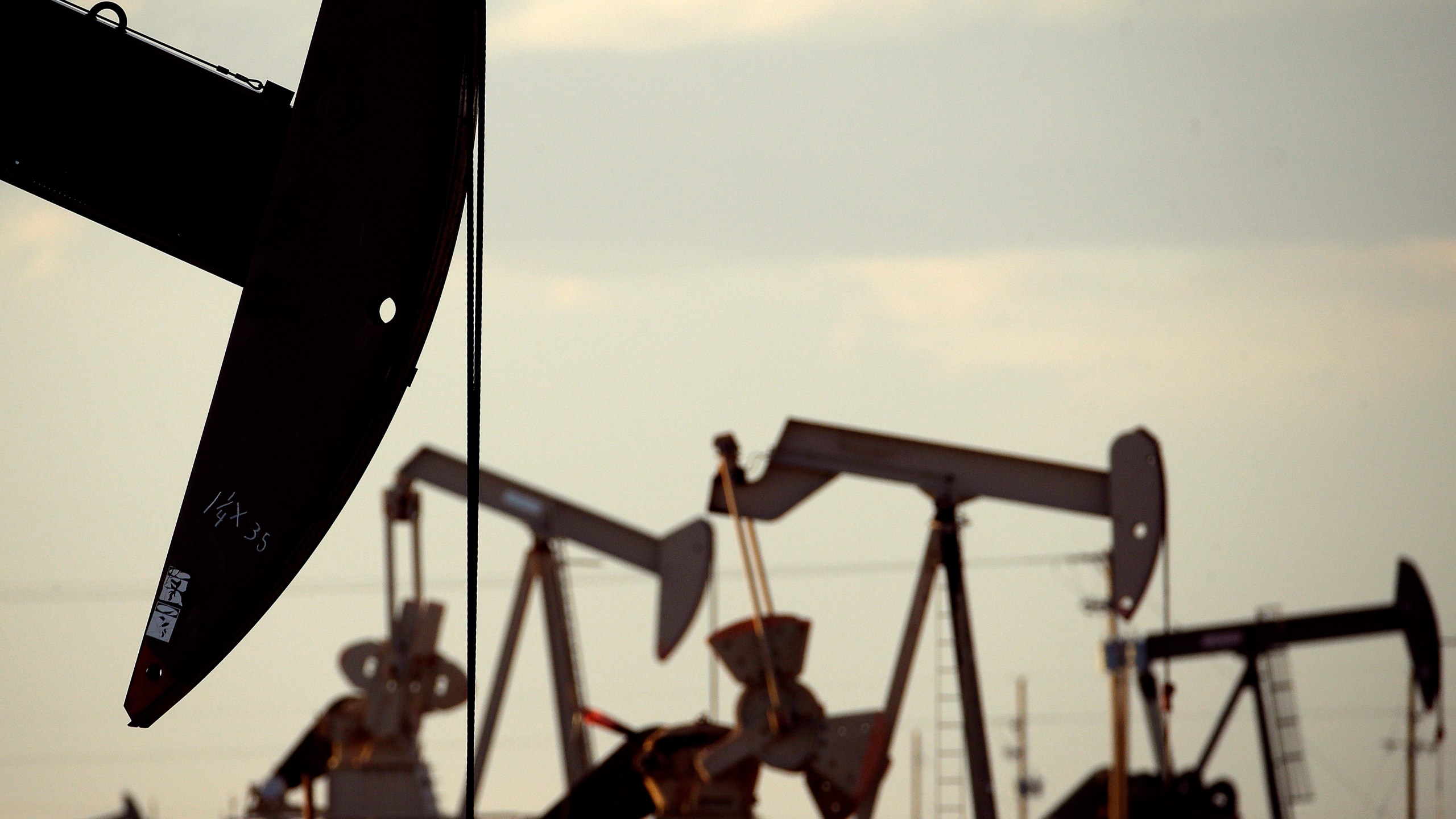 Pumpjacks work in a field near Lovington, N.M., on April 24, 2015. (Charlie Riedel / Associated Press)