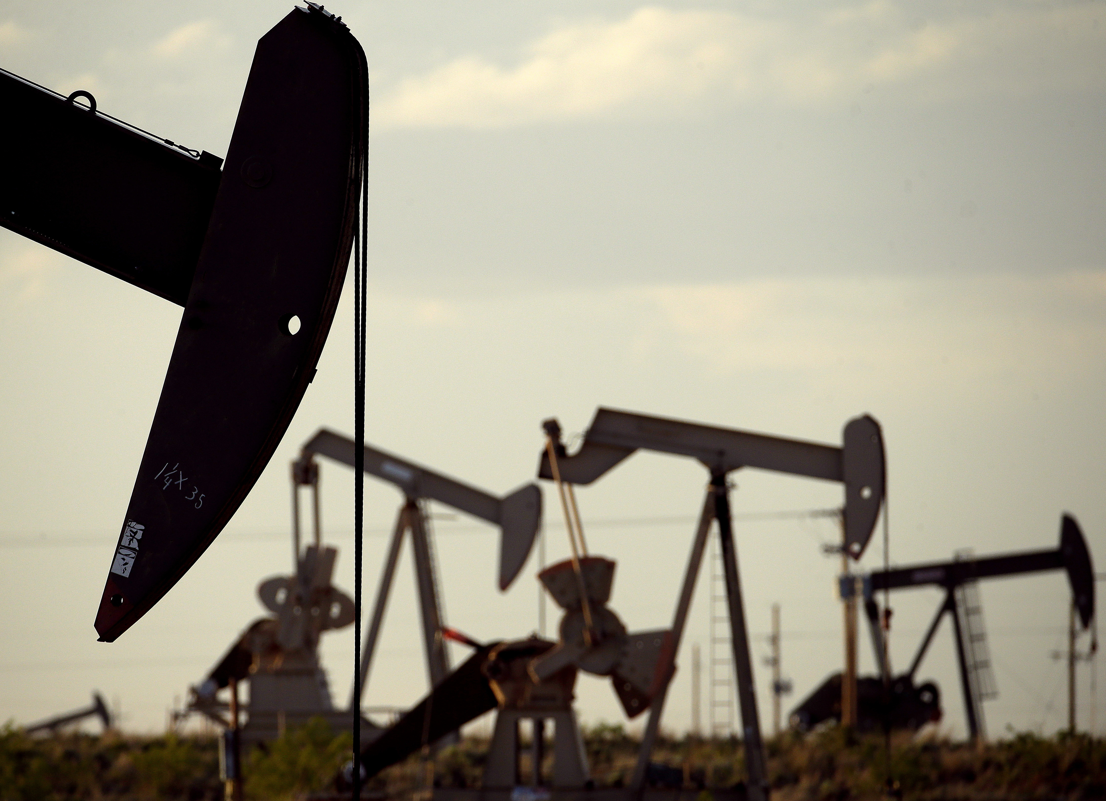 Pumpjacks work in a field near Lovington, N.M., on April 24, 2015. (Charlie Riedel / Associated Press)