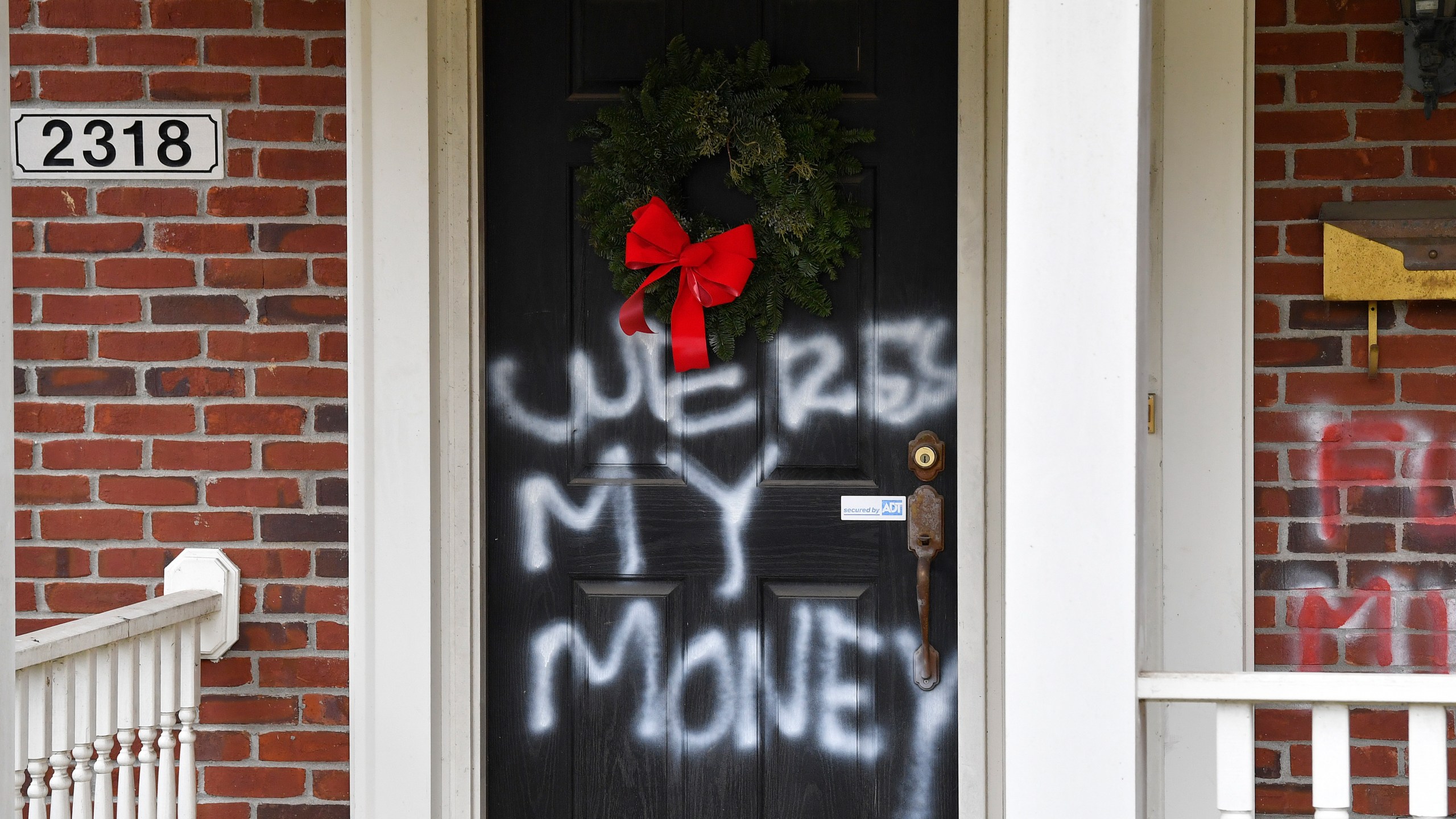 Graffiti reading, "Where's my money" is seen on a door of the home of Senate Majority Leader Mitch McConnell, R-Ky., in Louisville, Ky., on Saturday, Jan. 2, 2021. (Timothy D. Easley/AP Photo)