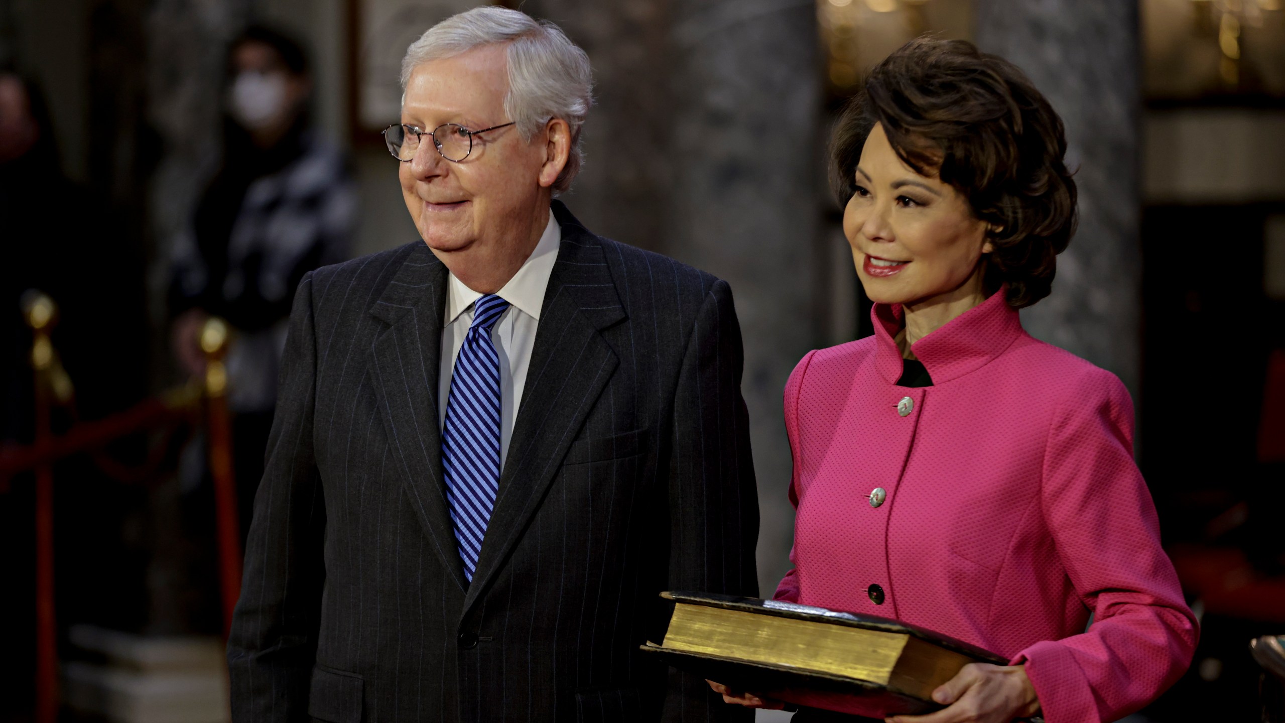 Sen. Mitch McConnell, R-Ky., and his wife Transportation Secretary Elaine Chao, wait for McConnell to be sworn in during a reenactment ceremony in the Old Senate Chamber at the Capitol in Washington, Jan. 3, 2021. (Samuel Corum/Pool via AP)