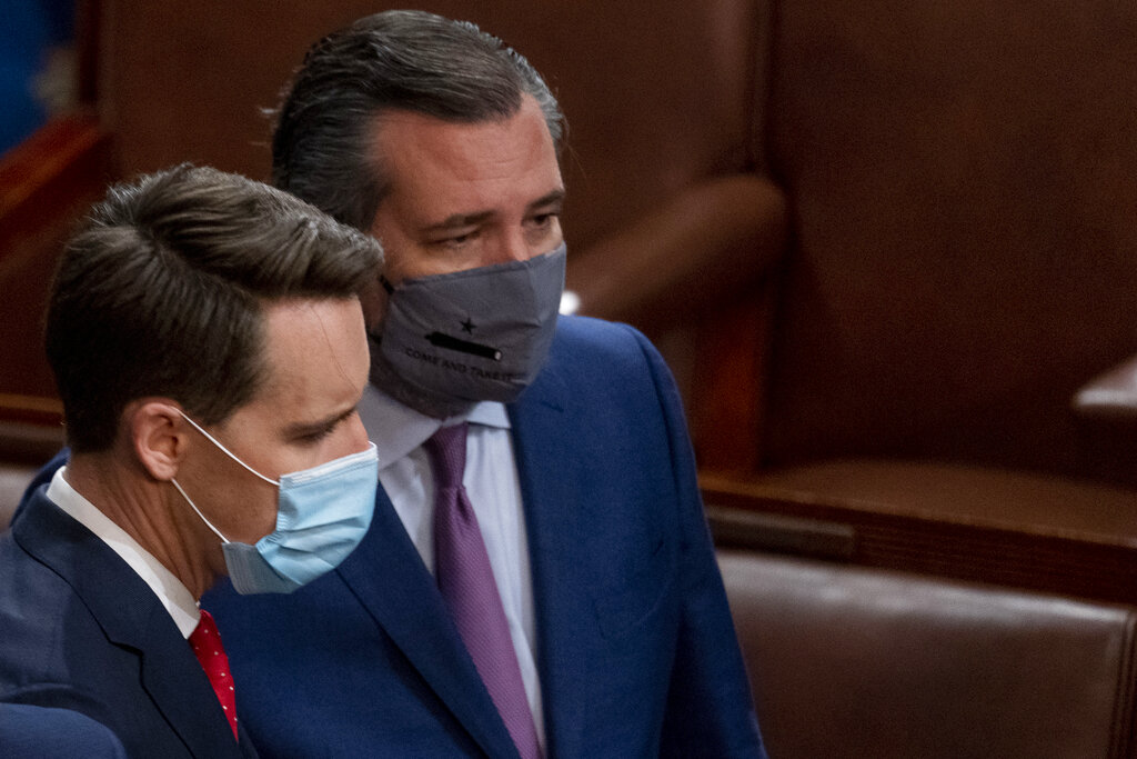 Sen. Josh Hawley, R-Mo., left, and Sen. Ted Cruz, R-Texas, right, speak after Republicans objected to certifying the Electoral College votes from Arizona, during a joint session of the House and Senate to confirm the electoral votes cast in November's election, at the Capitol, Wednesday, Jan 6, 2021. (AP Photo/Andrew Harnik)