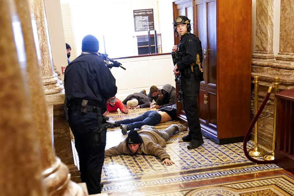 U.S. Capitol Police hold protesters at gun-point near the House Chamber inside the U.S. Capitol on Wednesday, Jan. 6, 2021, in Washington. (AP Photo/Andrew Harnik)