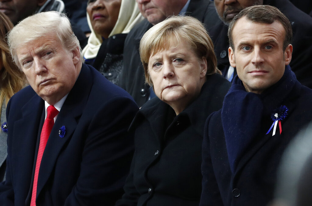 In this Nov.11, 2018 file photo, French President Emmanuel Macron, German Chancellor Angela Merkel and President Donald Trump attend a commemoration ceremony for Armistice Day, 100 years after the end of the First World War at the Arc de Triomphe in Paris, France. (Benoit Tessier/Pool Photo via AP)