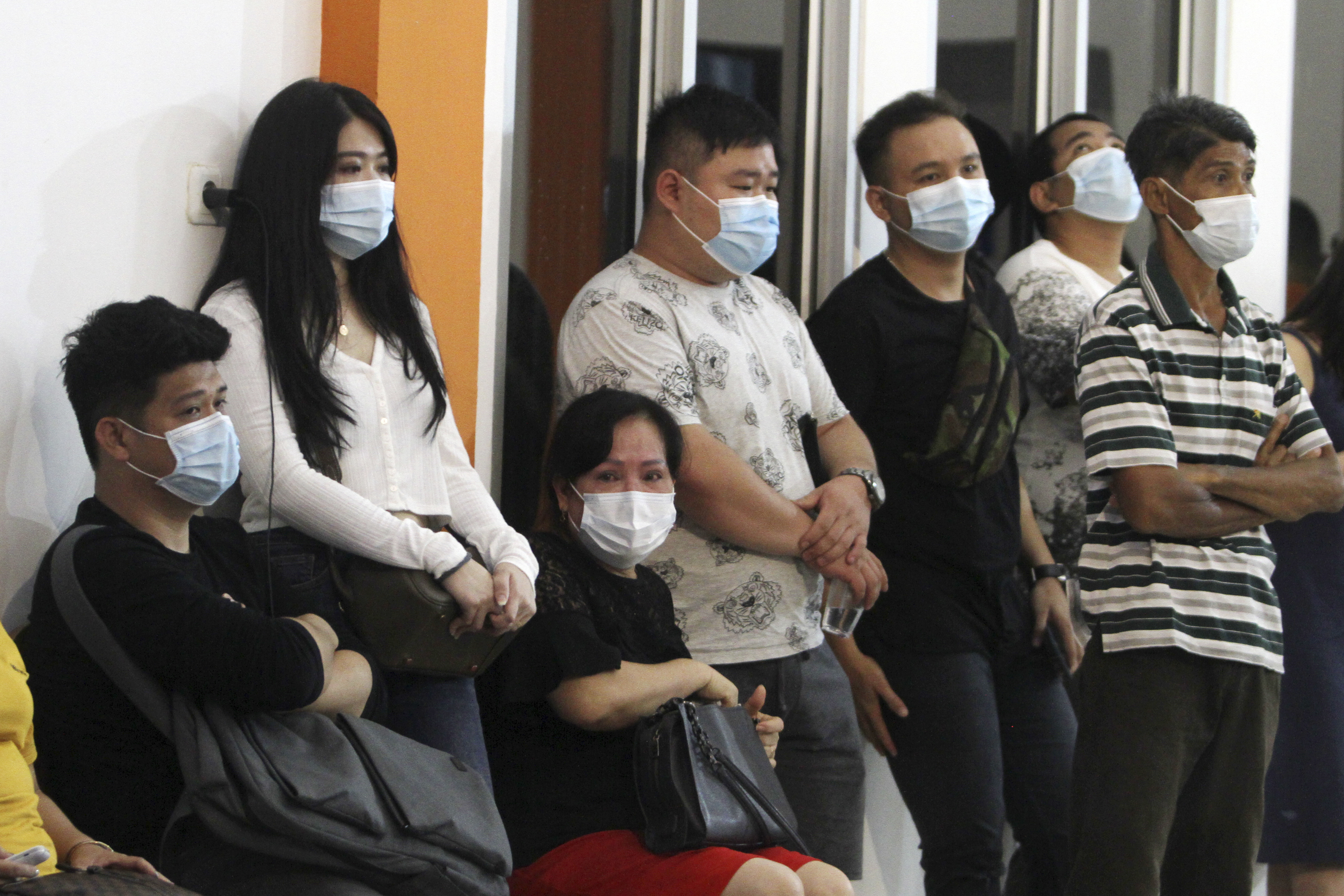 People wait for news on their relatives who are on board of Sriwijaya Air passenger jet that lost contact with air traffic controllers after take off, at Soepadio International Airport in Pontianak, West Kalimantan, Indonesia, Saturday, Jan. 9, 2021. (AP Photo/Helmansyah)