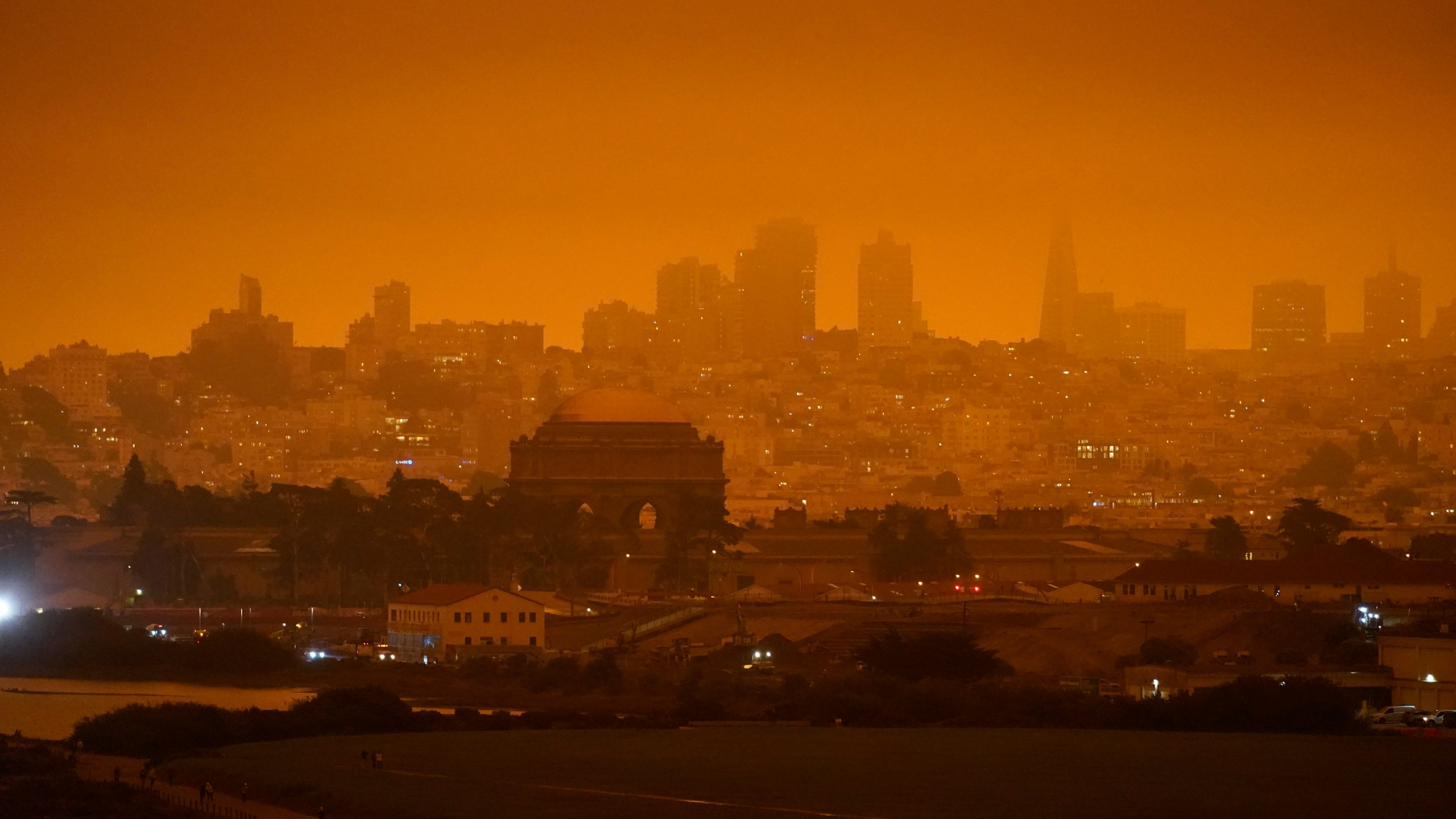 In this Sept. 9, 2020, file photo, the San Francisco skyline in the distance behind Crissy Field is barely visible due to smoke from wildfires burning across California. (Eric Risberg/Associated Press)